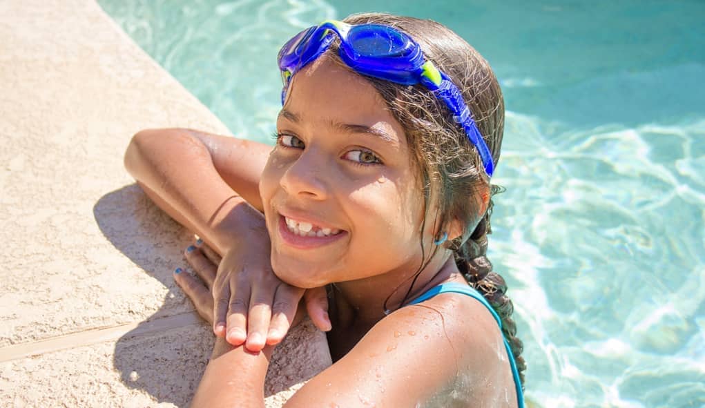 girl smiling while in swimming pool